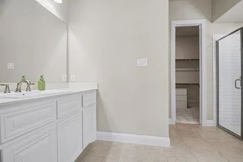 a bathroom with a sink vanity and mirror