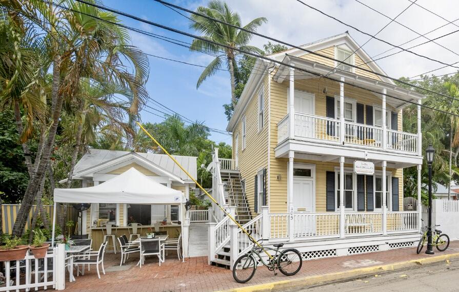 405 Petronia Street Key West, FL 33040 - Photo 1 of 47 a view of a patio with table and chairs under an umbrella