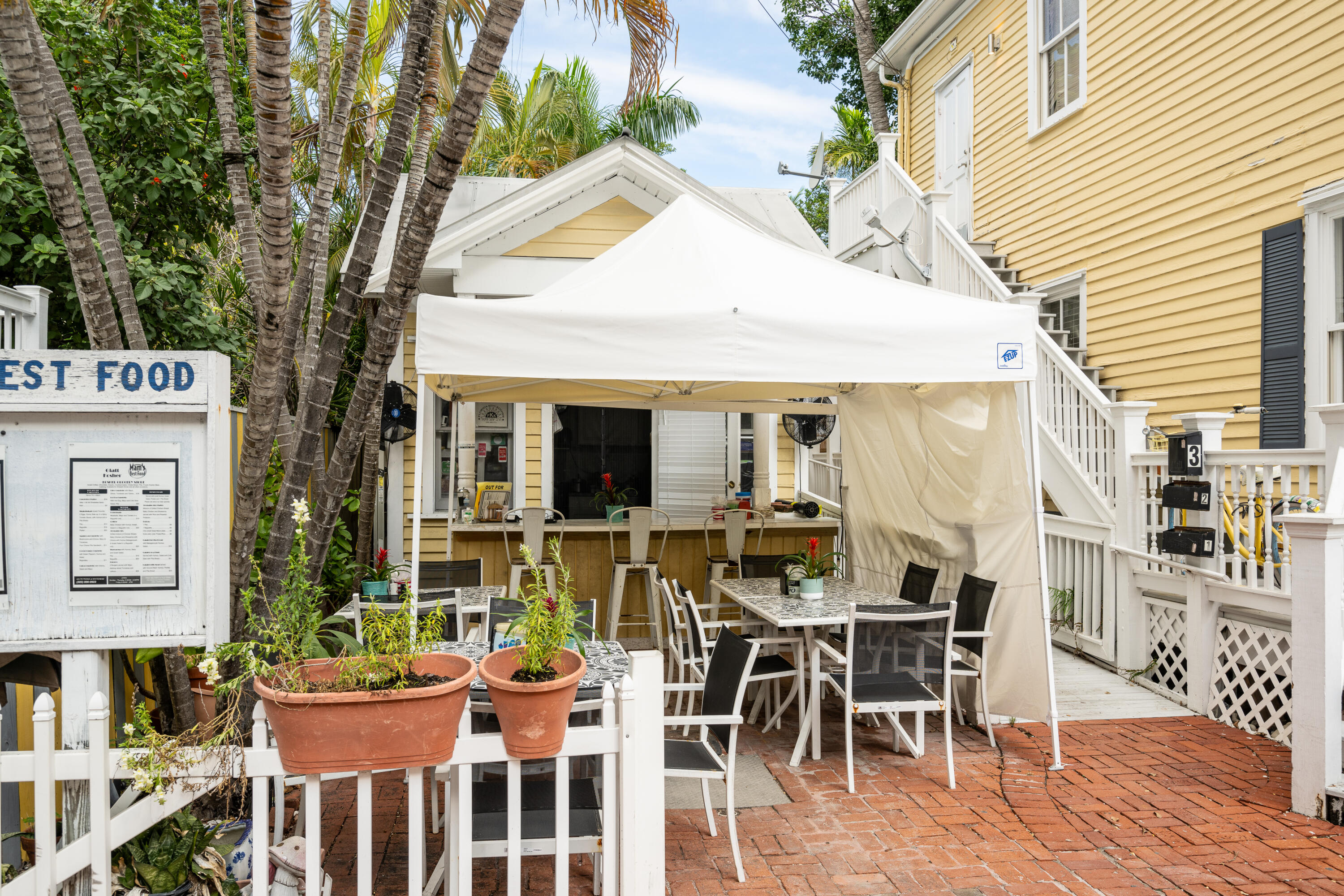 405 Petronia Street Key West, FL 33040 - Photo 11 of 47 a view of a patio with table and chairs and potted plants
