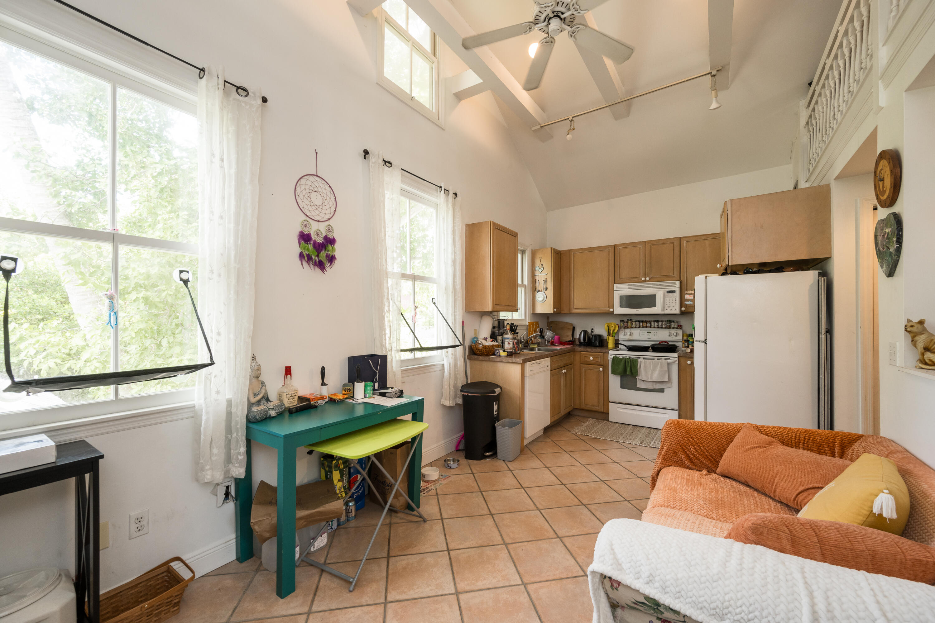 405 Petronia Street Key West, FL 33040 - Photo 13 of 47 a kitchen with stainless steel appliances kitchen island granite countertop a refrigerator and a stove top oven