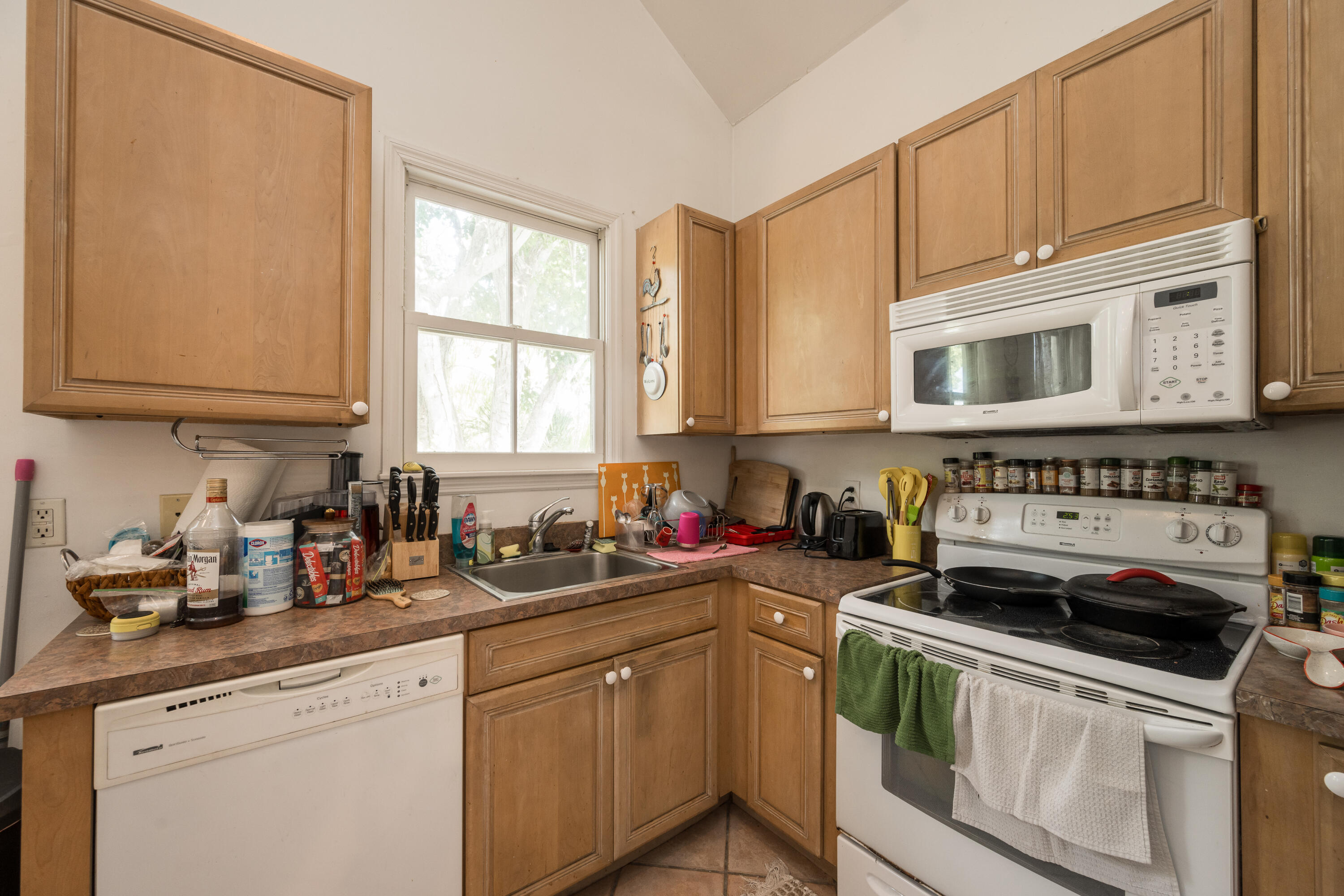 405 Petronia Street Key West, FL 33040 - Photo 14 of 47 a kitchen with stainless steel appliances granite countertop a sink a stove and cabinets