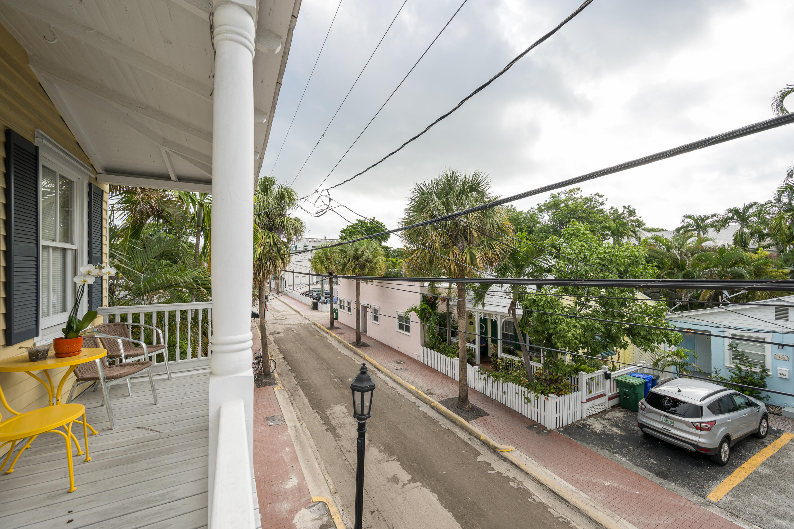 405 Petronia Street Key West, FL 33040 - Photo 20 of 47 a view of a balcony with chair and wooden floor