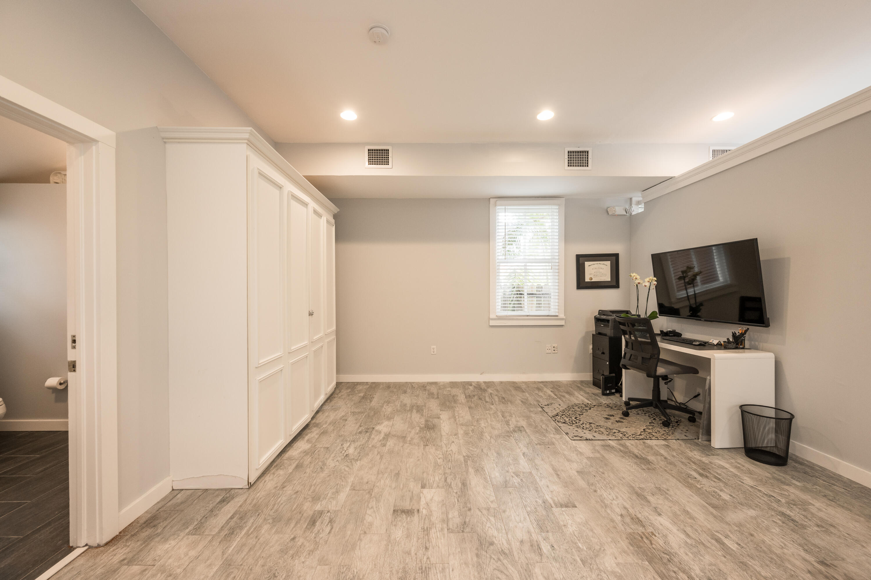 405 Petronia Street Key West, FL 33040 - Photo 35 of 47 a view of a livingroom with a flat screen tv wooden floor and a window