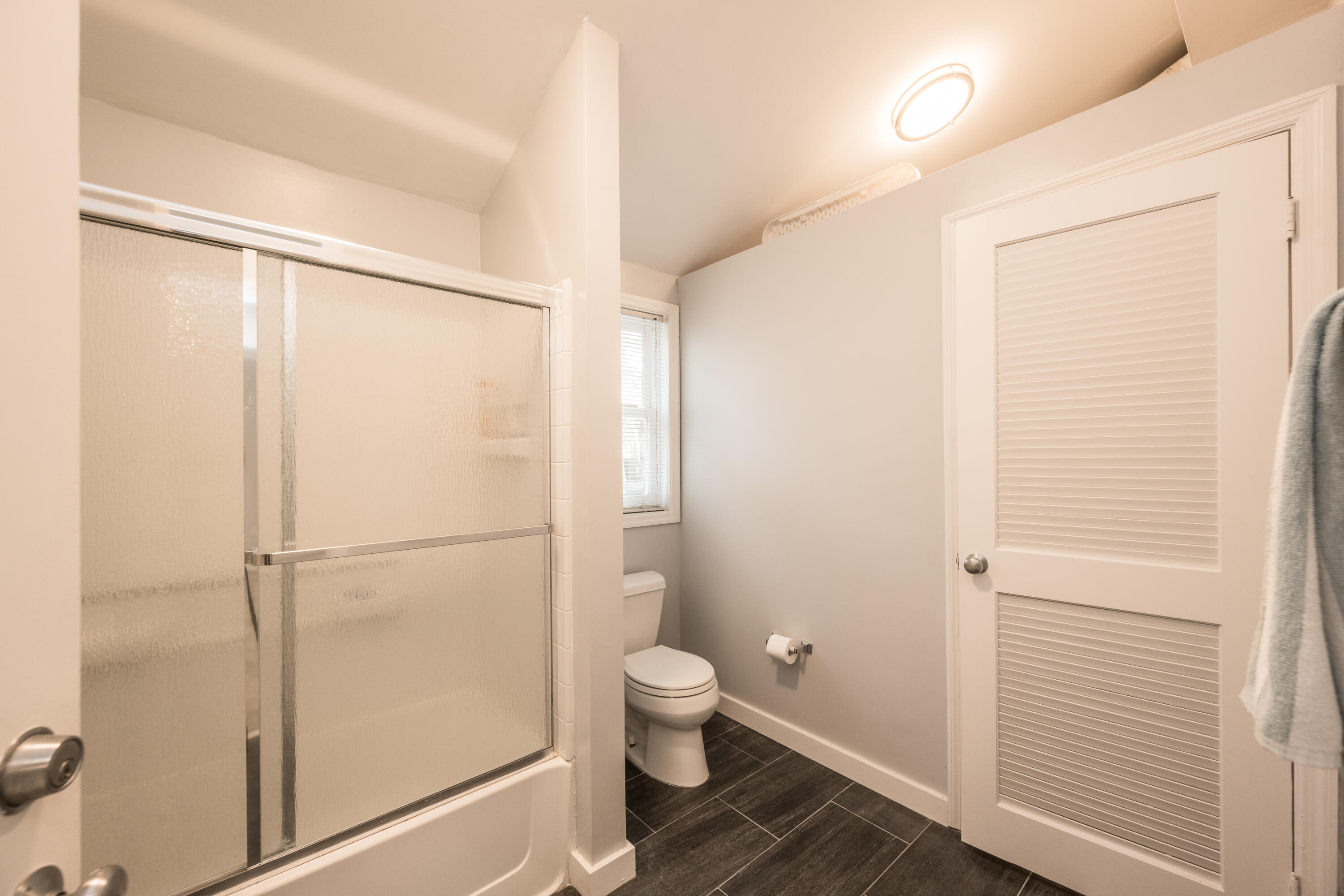 405 Petronia Street Key West, FL 33040 - Photo 36 of 47 a bathroom with a granite countertop sink toilet and a shower
