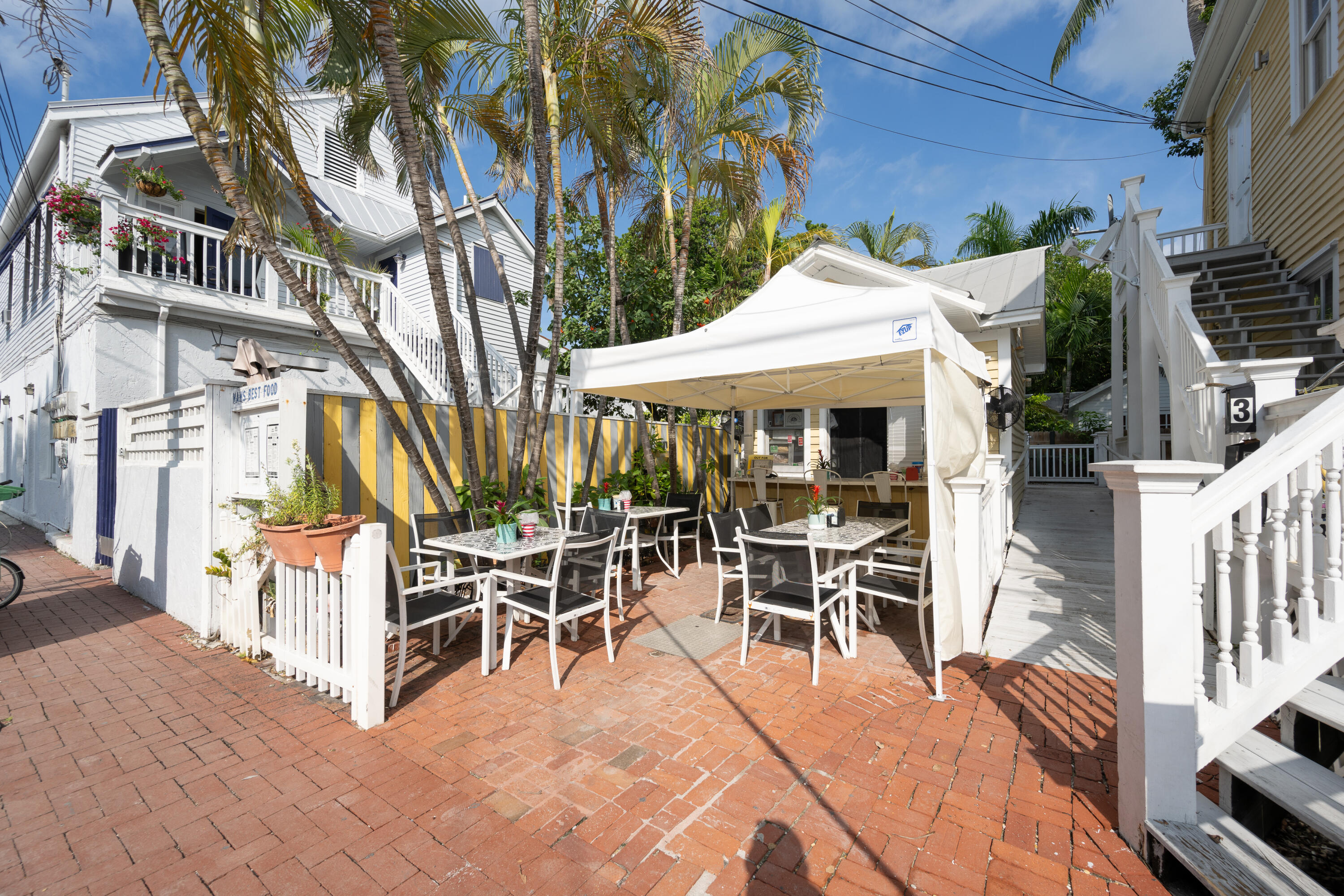 405 Petronia Street Key West, FL 33040 - Photo 40 of 47 a view of a patio with table and chairs potted plants
