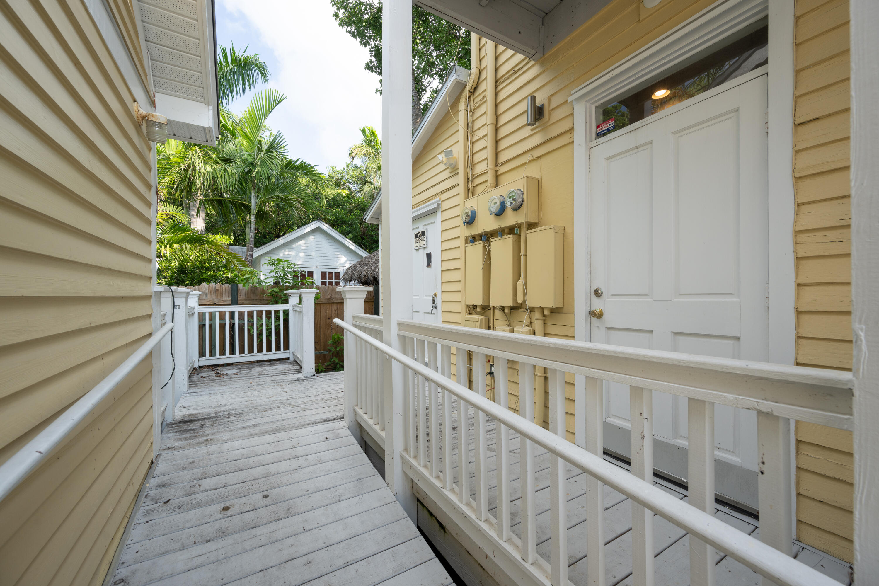 405 Petronia Street Key West, FL 33040 - Photo 41 of 47 a view of a balcony with wooden floor and fence