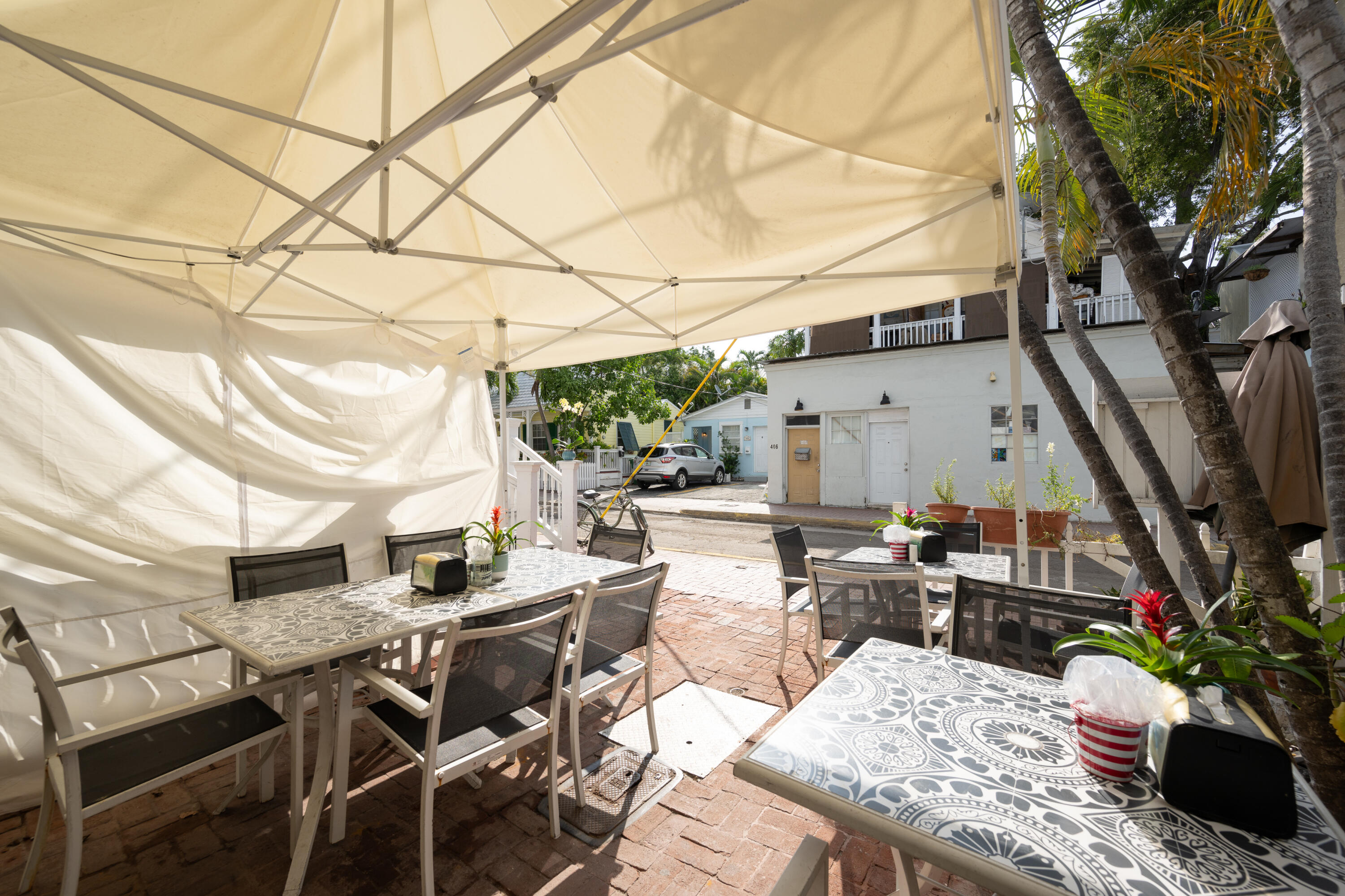 405 Petronia Street Key West, FL 33040 - Photo 43 of 47 a view of a patio with table and chairs and potted plants