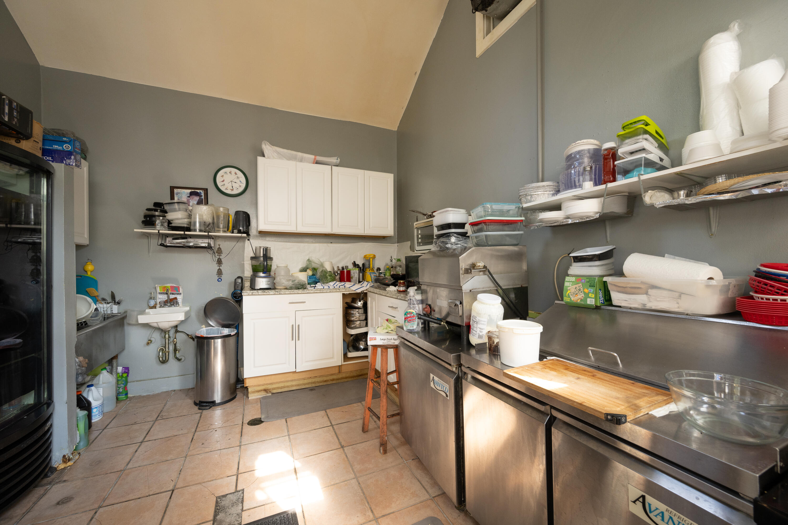 405 Petronia Street Key West, FL 33040 - Photo 44 of 47 a kitchen with a sink a stove and cabinets