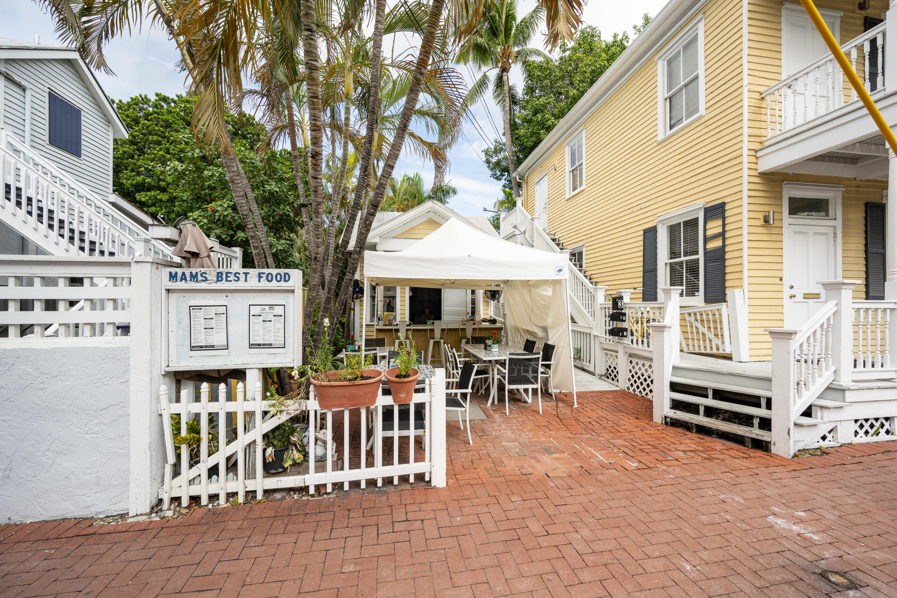405 Petronia Street Key West, FL 33040 - Photo 10 of 47 a front view of a house with outdoor seating