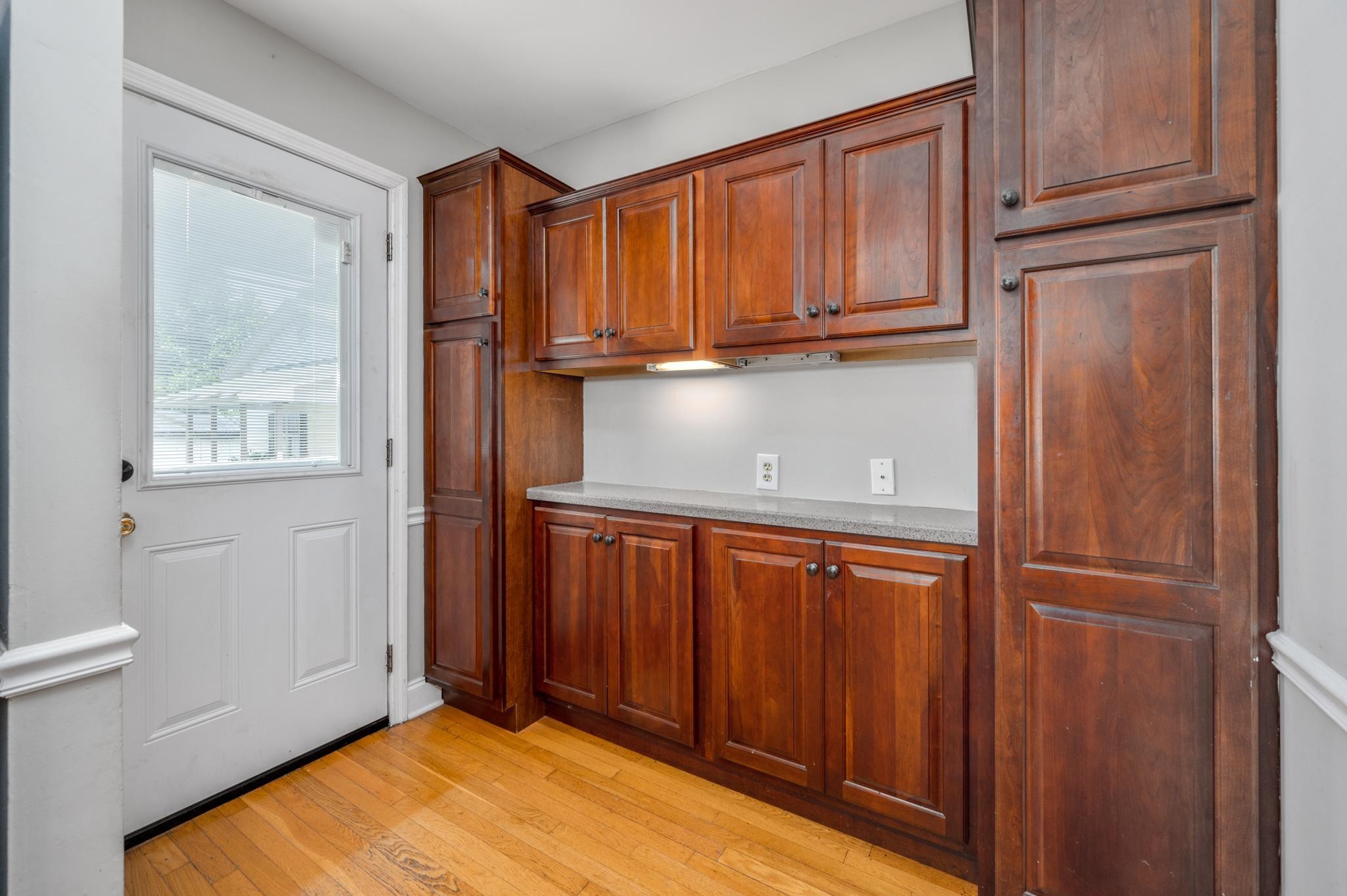 5799 Cane Ridge Road Antioch, TN 37013 - Photo 11 of 45 a view of a kitchen with wooden floor and cabinets