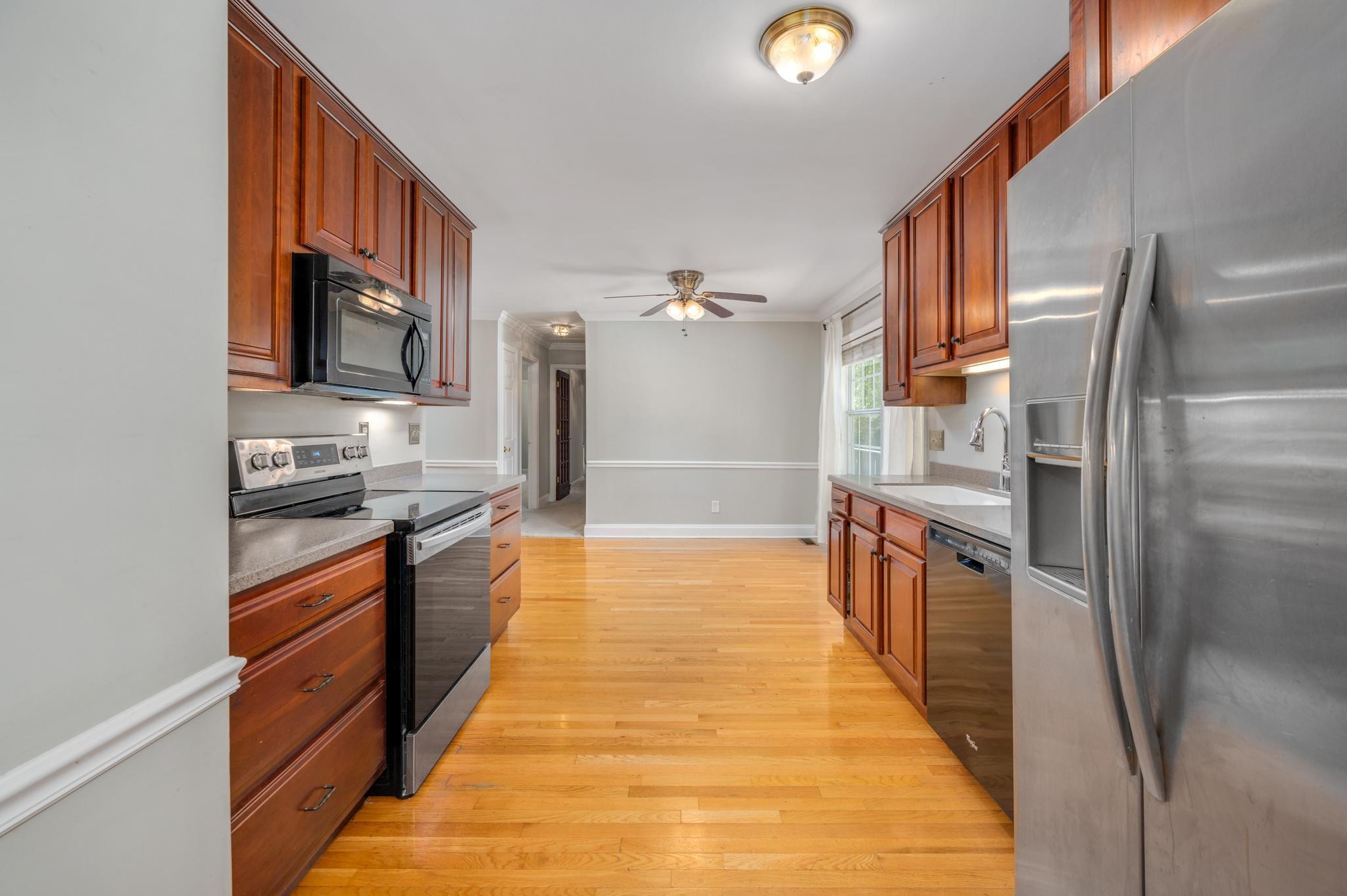 5799 Cane Ridge Road Antioch, TN 37013 - Photo 12 of 45 a kitchen with stainless steel appliances granite countertop a refrigerator and a stove top oven