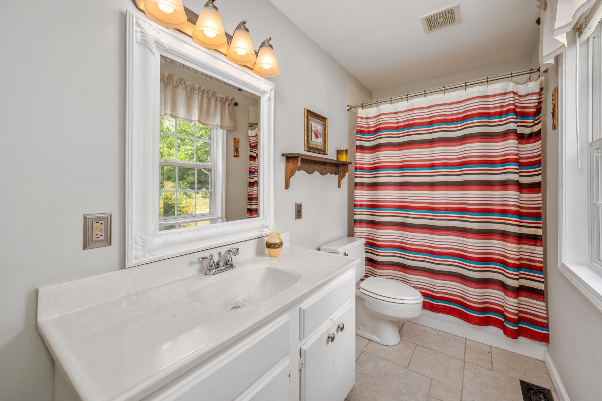 5799 Cane Ridge Road Antioch, TN 37013 - Photo 14 of 45 a bathroom with a sink toilet and shower