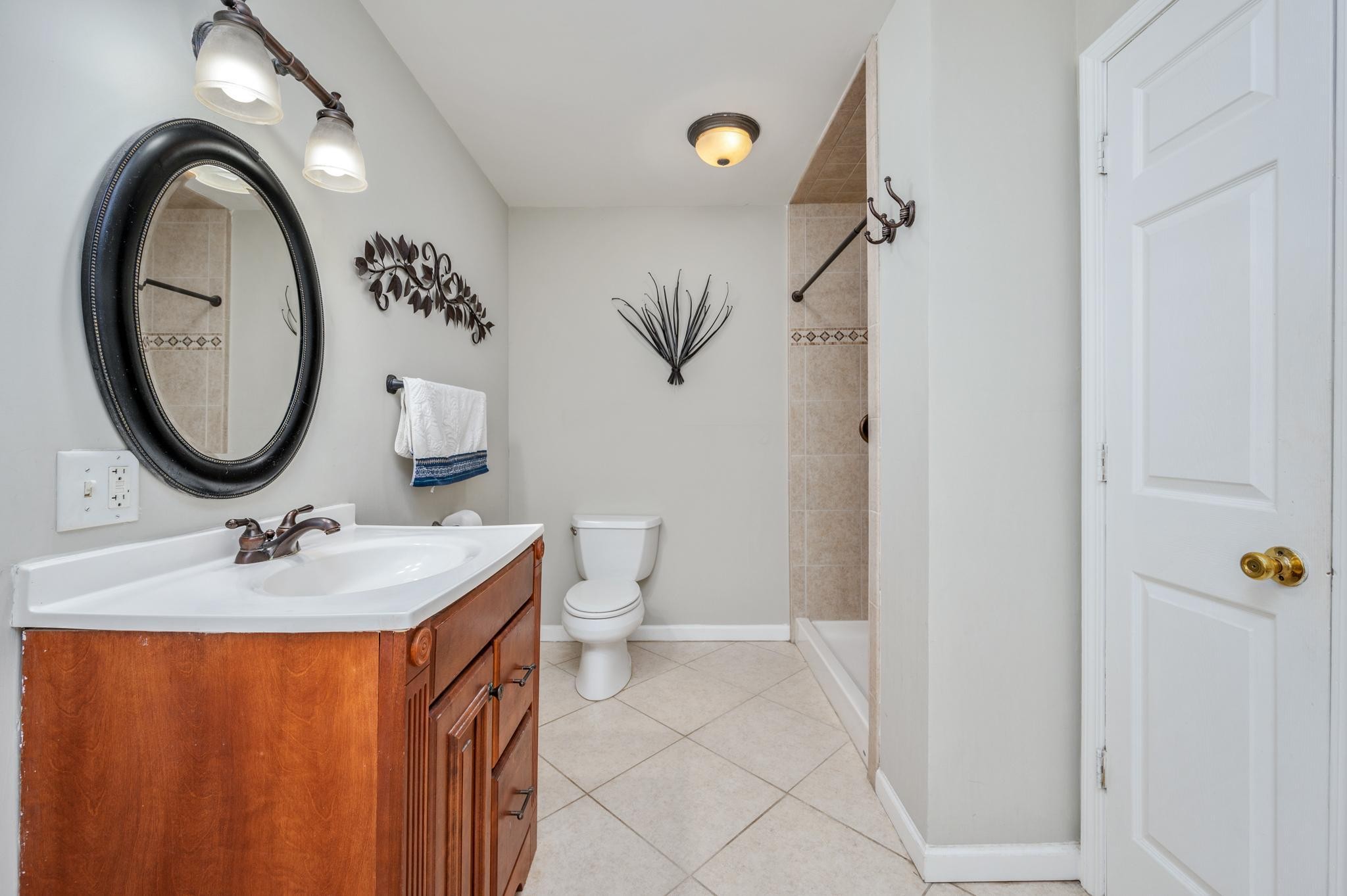 5799 Cane Ridge Road Antioch, TN 37013 - Photo 17 of 45 a bathroom with a sink toilet and mirror