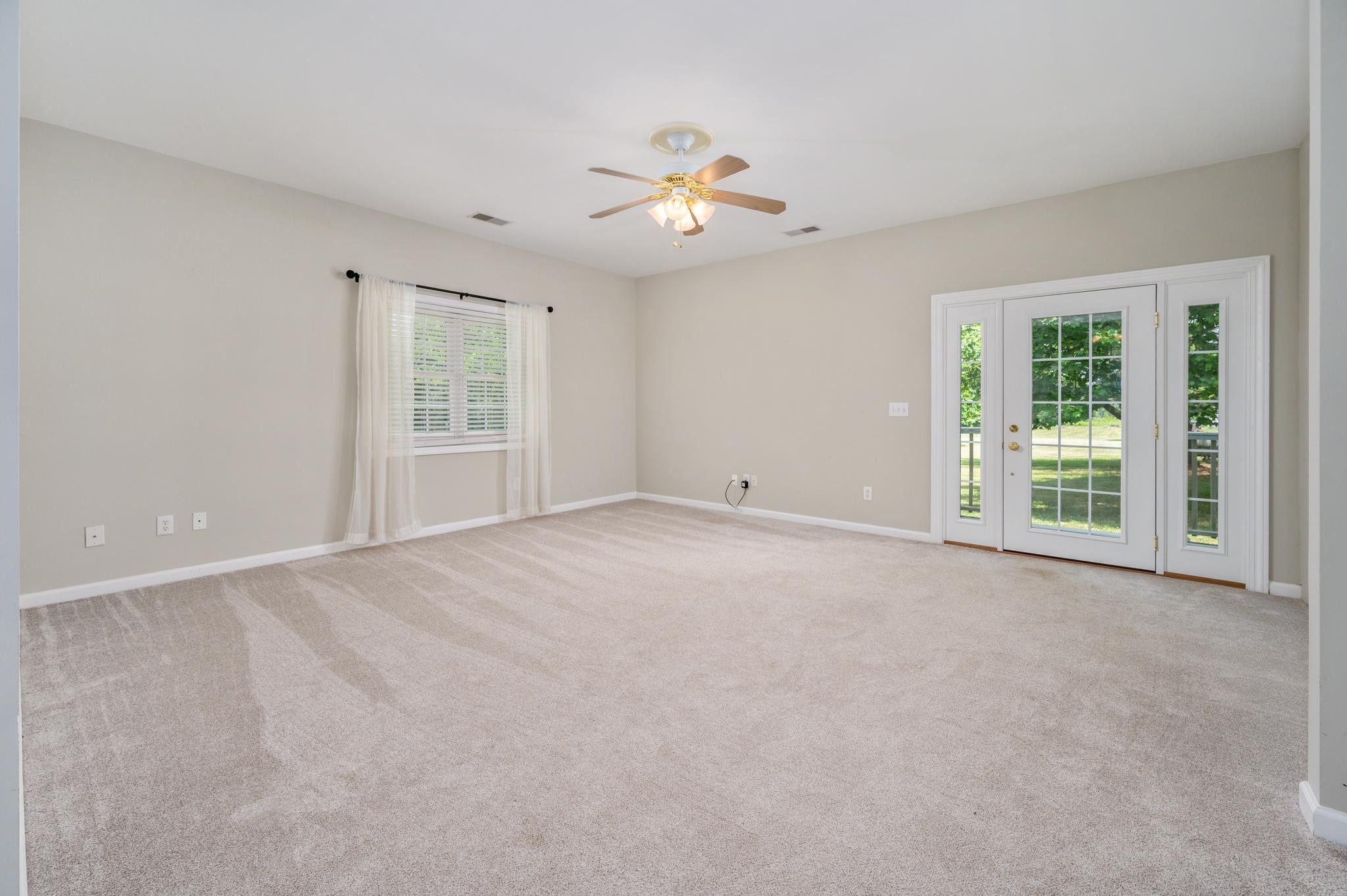 5799 Cane Ridge Road Antioch, TN 37013 - Photo 20 of 45 an empty room with windows and chandelier fan