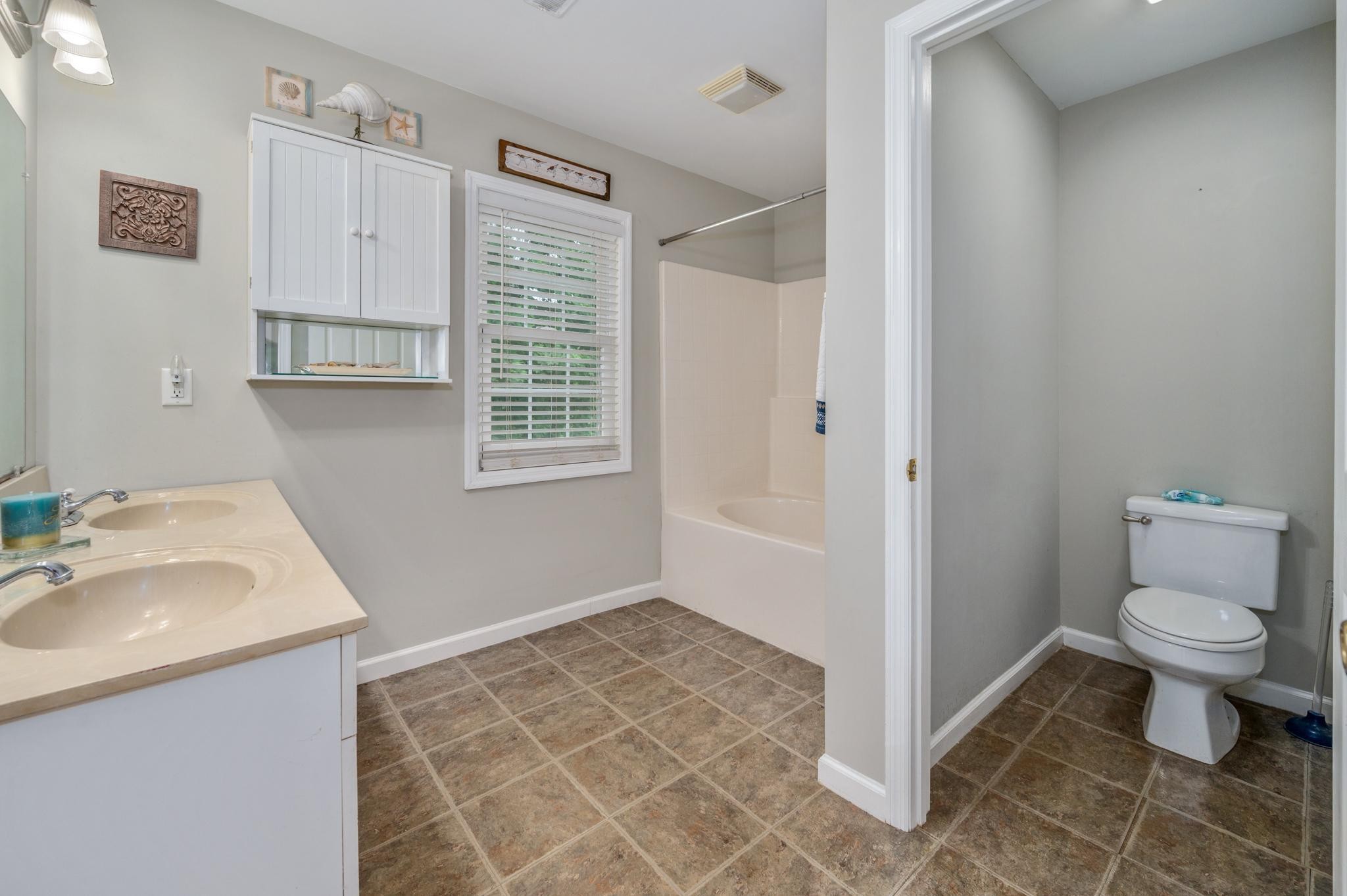 5799 Cane Ridge Road Antioch, TN 37013 - Photo 24 of 45 a bathroom with a sink a toilet and a vanity