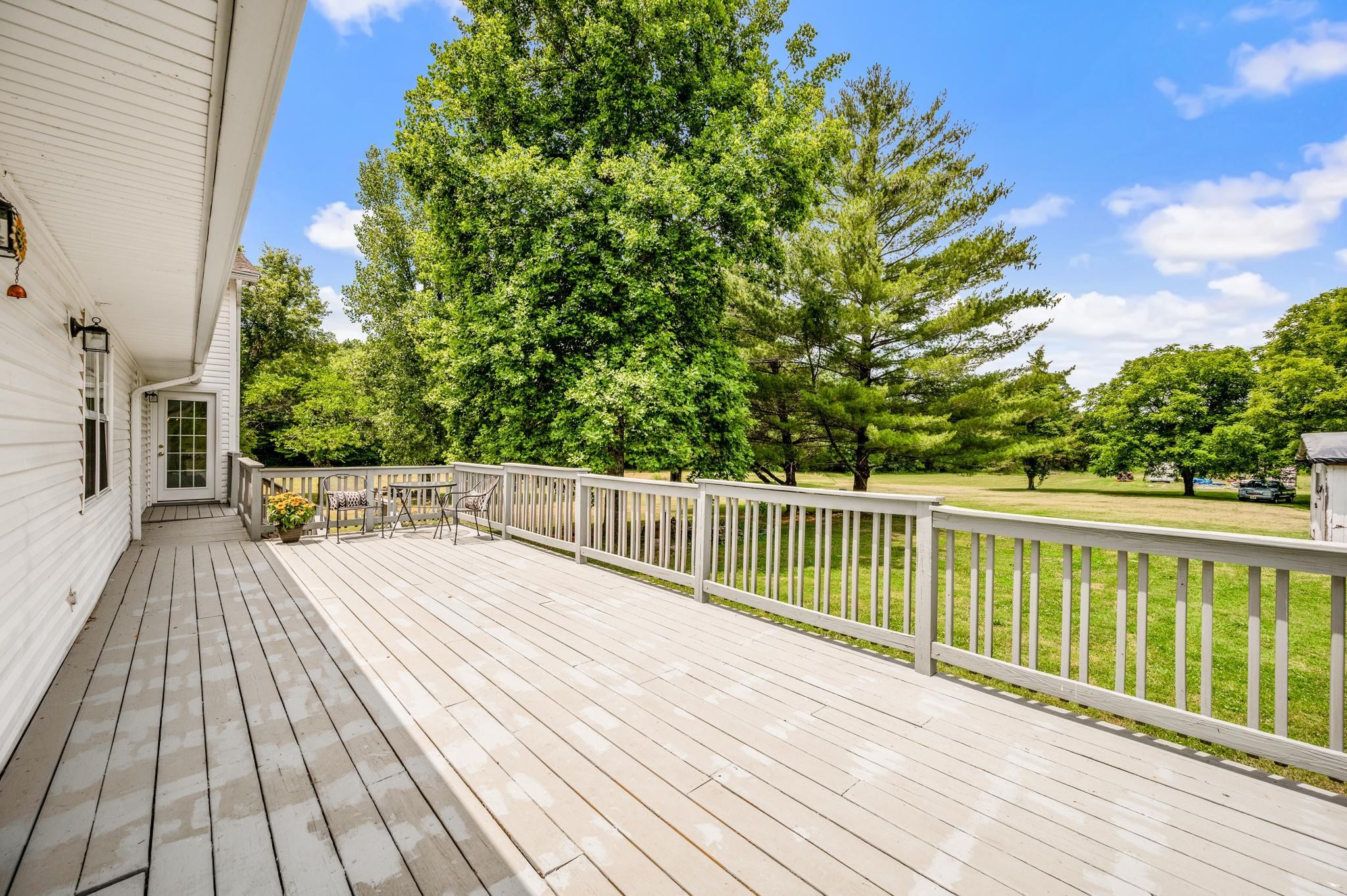 5799 Cane Ridge Road Antioch, TN 37013 - Photo 26 of 45 a balcony with wooden floor and trees in the background