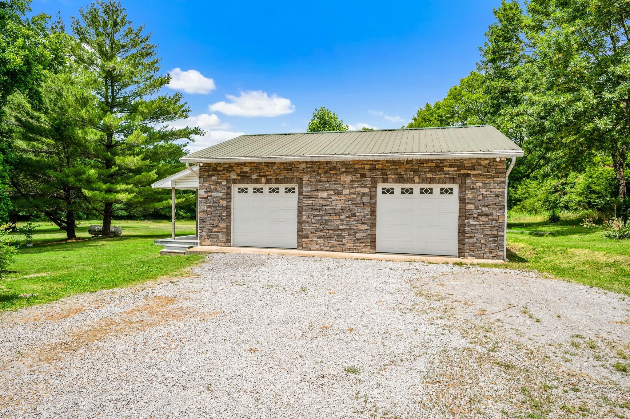 5799 Cane Ridge Road Antioch, TN 37013 - Photo 29 of 45 a front view of a house with a yard and garage