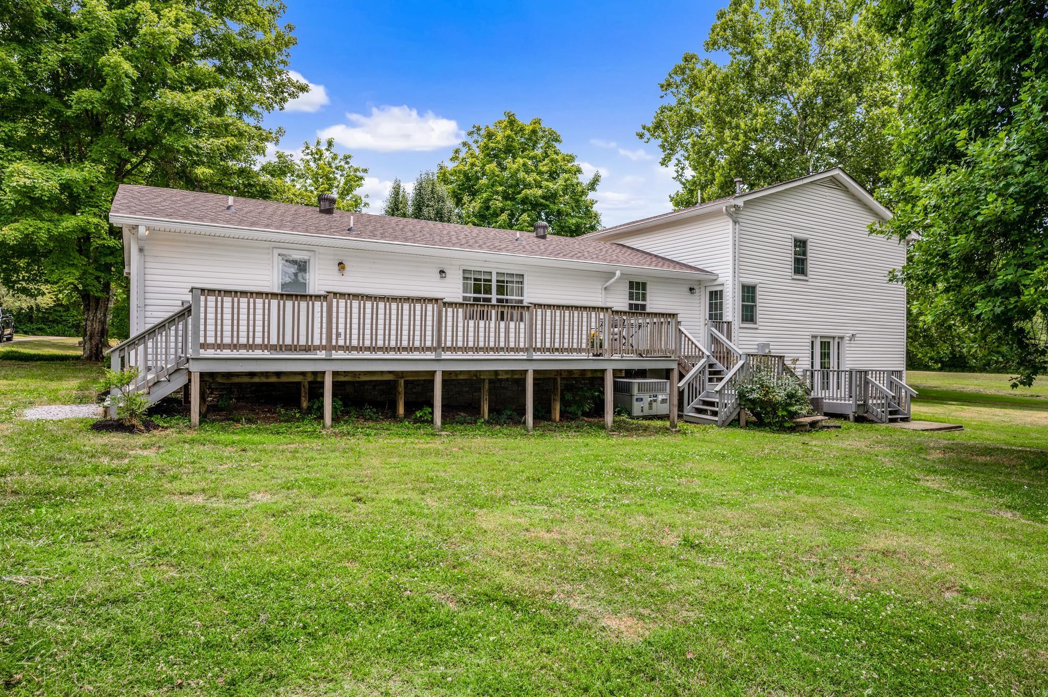 5799 Cane Ridge Road Antioch, TN 37013 - Photo 34 of 45 a backyard of a house with wooden deck and seating space