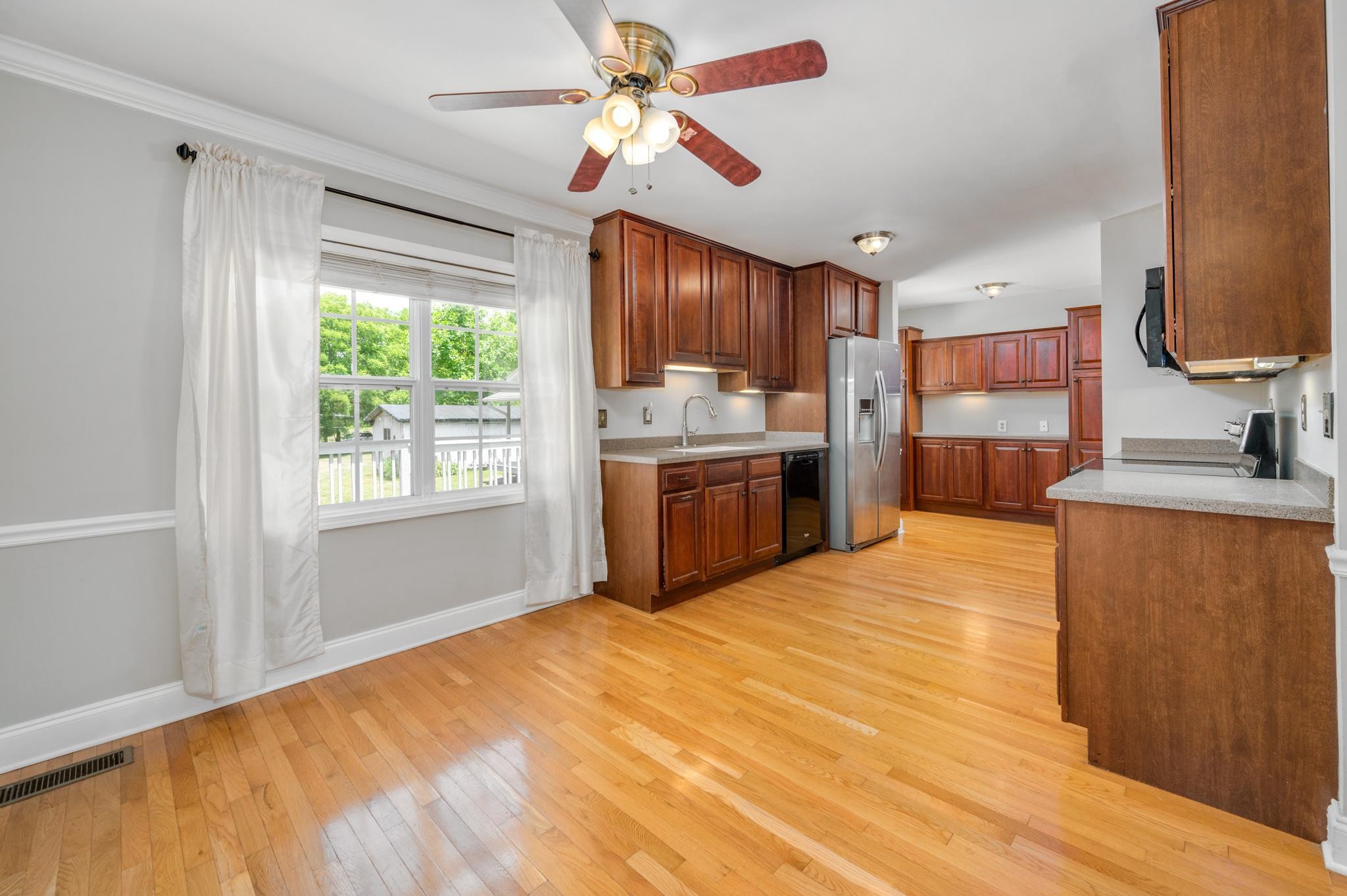 5799 Cane Ridge Road Antioch, TN 37013 - Photo 9 of 45 a kitchen with stainless steel appliances granite countertop a sink and a refrigerator