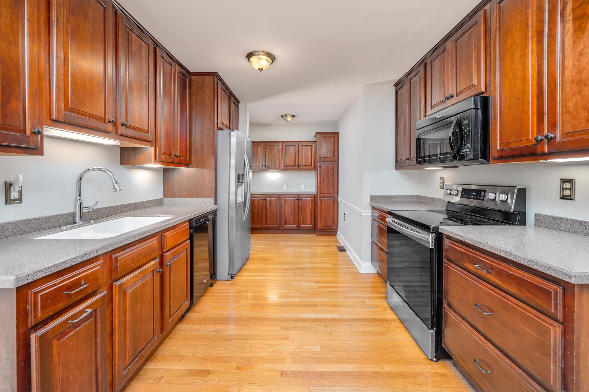 5799 Cane Ridge Road Antioch, TN 37013 - Photo 10 of 45 a large kitchen with stainless steel appliances granite countertop wooden cabinets a sink and dishwasher
