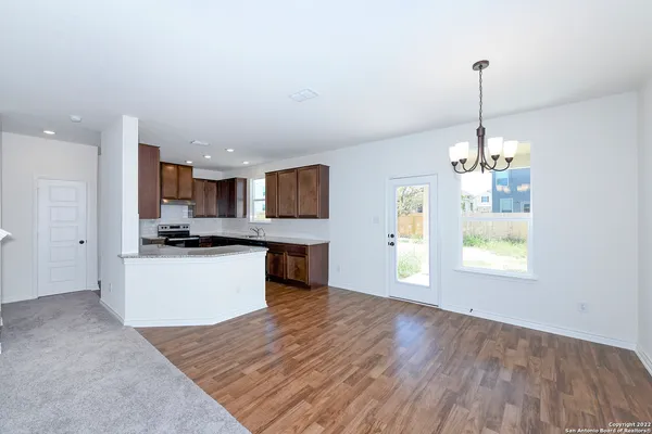 a large kitchen with kitchen island a sink dishwasher a refrigerator and a stove top oven