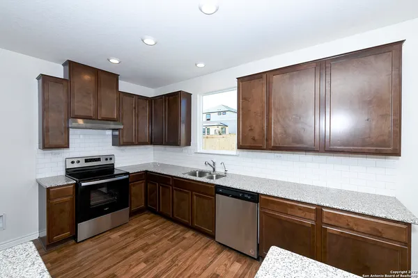 a kitchen with wooden cabinets and a sink