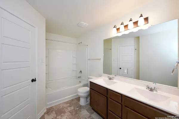 a bathroom with a sink vanity and mirror