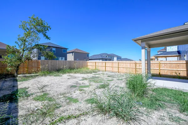 a view of a house with a backyard