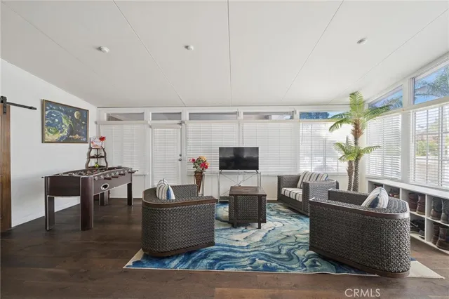 wooden floor in an empty room with a chandelier fan