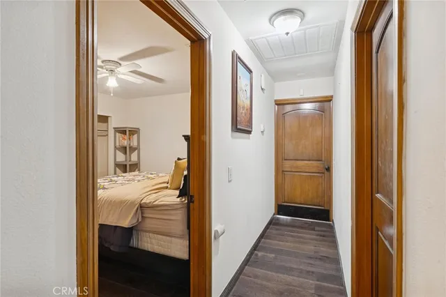 a view of a room with wooden floor stairs and a bathroom
