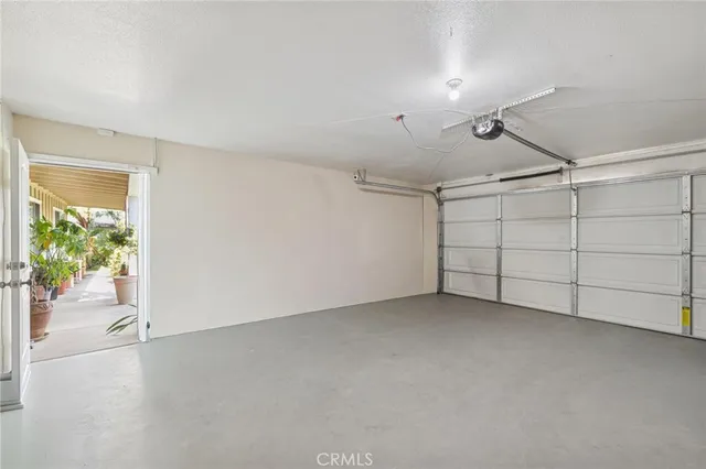 a view of a wooden house with a large tree and wooden fence