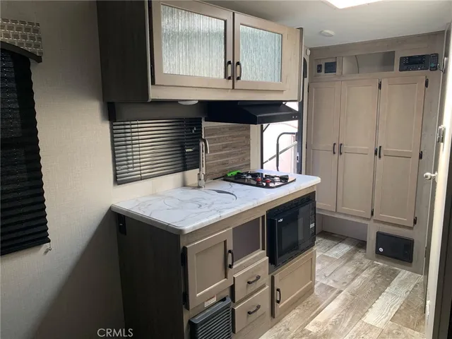 a view of a patio with couches chairs and potted plants