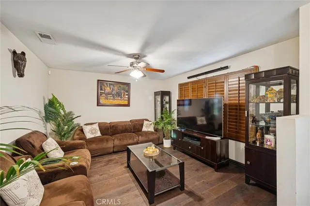 a living room with a table chairs and a wooden floor