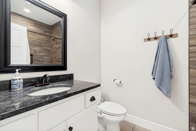 332 South 500 West Payson, UT 84651 - Photo 27 of 50 Bathroom vanity featuring an integrated sink, dark countertop, white cabinetry, and framed mirror