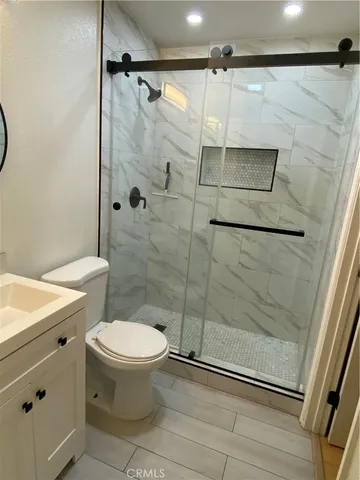 a bathroom with a toilet and a shower