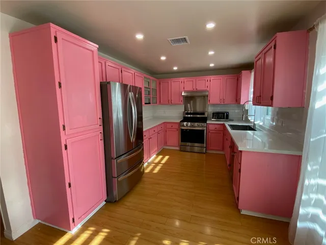 a kitchen with stainless steel appliances granite countertop a refrigerator stove microwave and sink