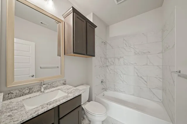 an empty room with windows and chandelier fan