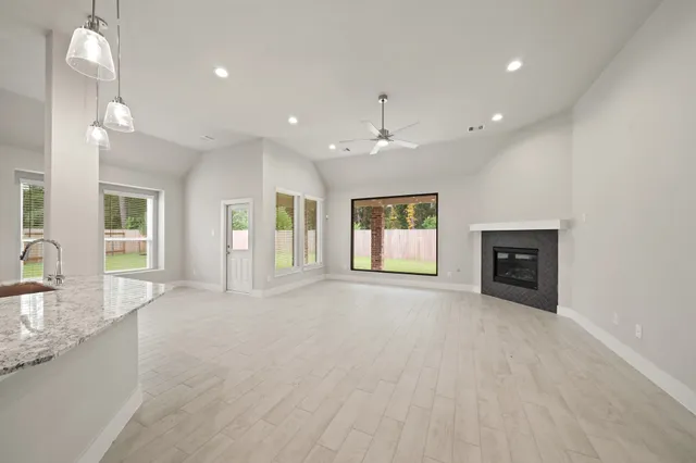 a view of an empty room with window and cabinet