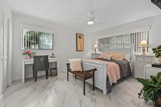 a bedroom with a bed and a table in it