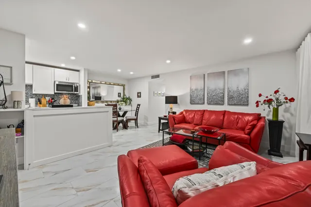 a living room with furniture and kitchen view