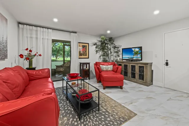 a living room with furniture a window and a fireplace
