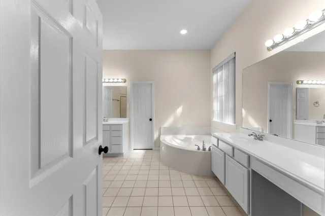 a bathroom with a bathtub and sink