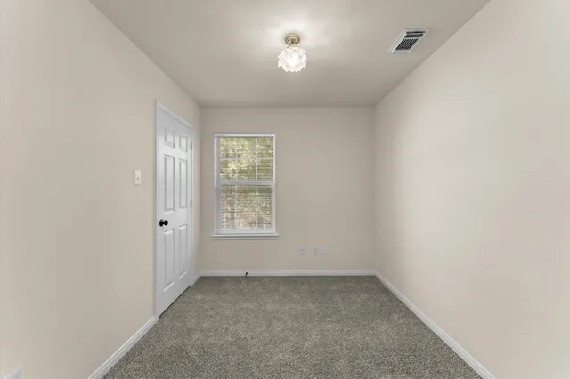 an empty room with a fan and a fan