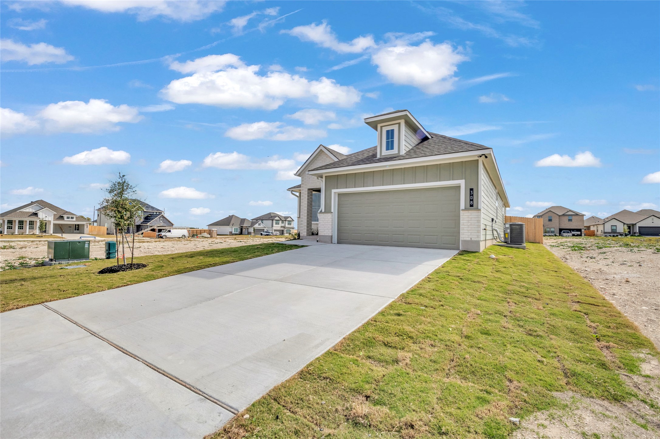 308 Boatright Boulevard Jarrell, TX 76537 - Photo 1 of 31 View of front of house with board and batten siding, a residential view, concrete driveway, and an attached garage