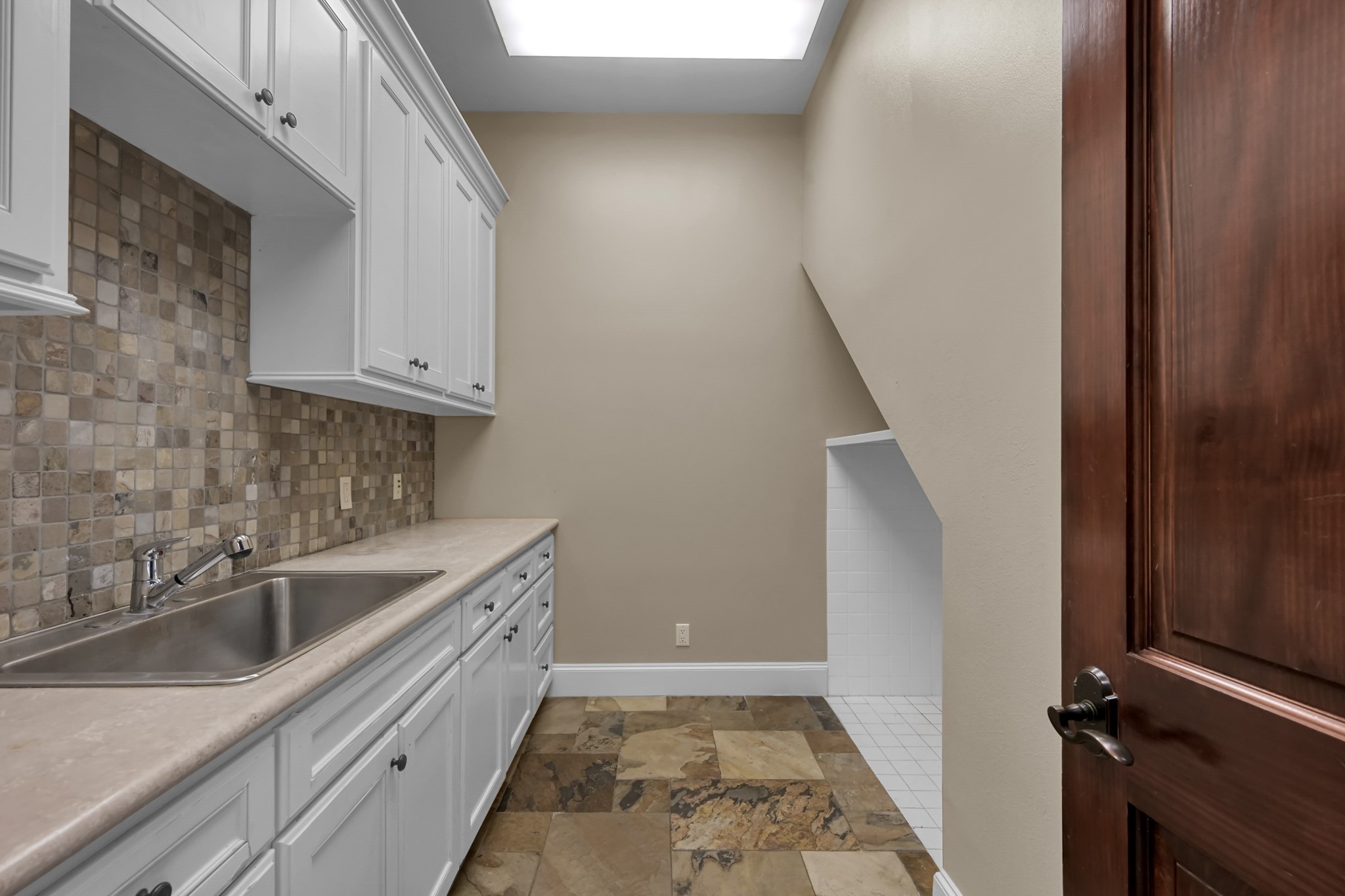 9602 Chatfield Street Houston, TX 77025 - Photo 15 of 48 a kitchen with a sink and cabinets