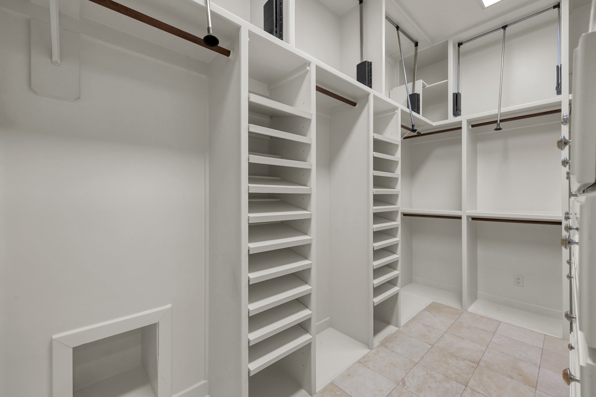 9602 Chatfield Street Houston, TX 77025 - Photo 23 of 48 a view of walk in closet with empty racks
