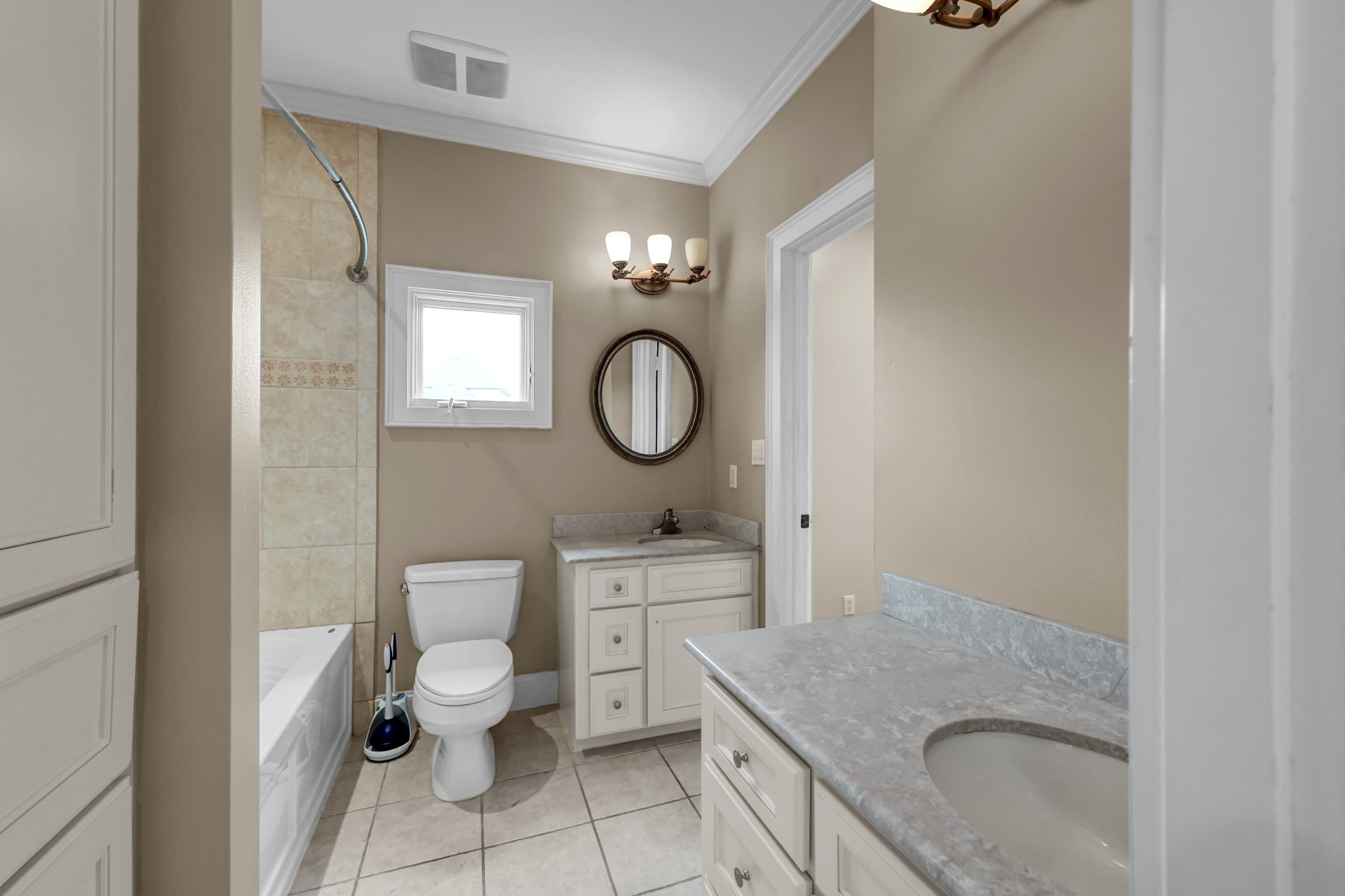 9602 Chatfield Street Houston, TX 77025 - Photo 37 of 48 a bathroom with a granite countertop toilet a sink and a mirror