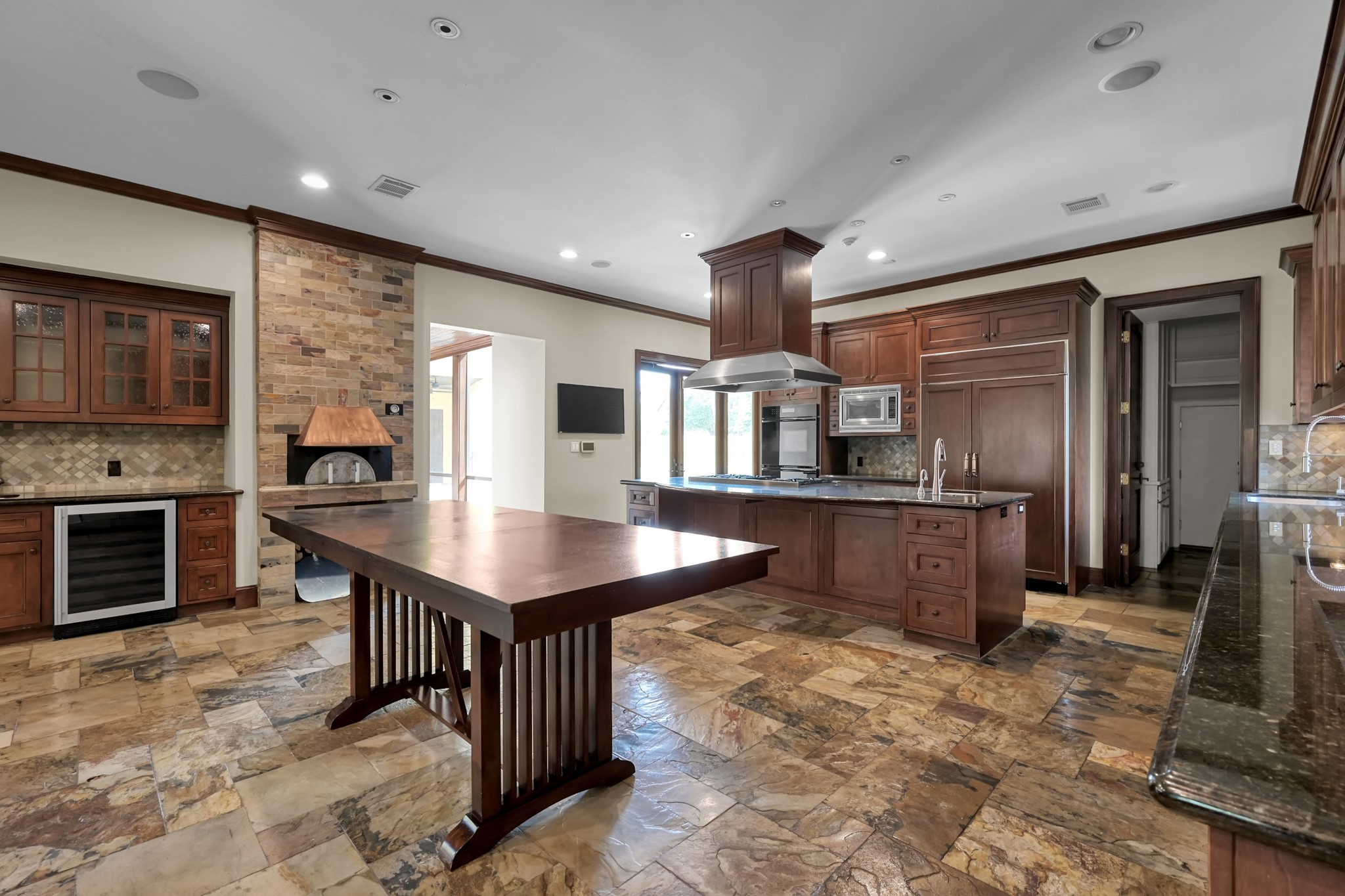 9602 Chatfield Street Houston, TX 77025 - Photo 9 of 48 a kitchen with a refrigerator a oven a sink and a dining table