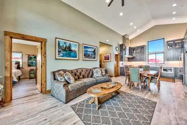 a living room with furniture a wooden floor and a table