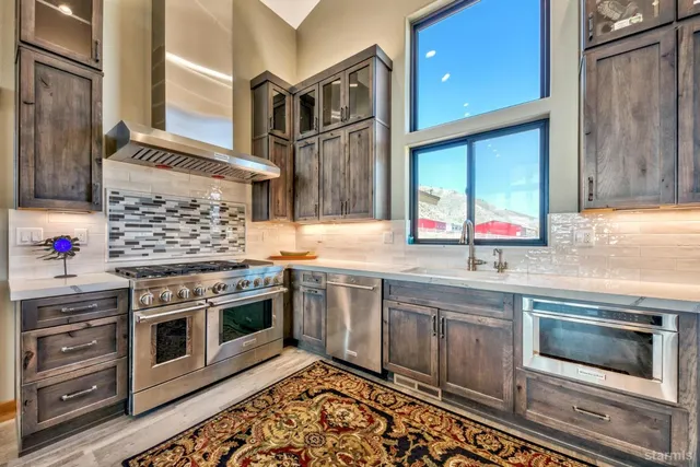 a kitchen with stainless steel appliances granite countertop a stove and cabinets
